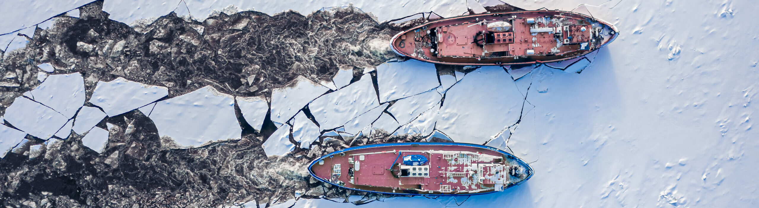 Icebreakers on Vistula river crushes the ice, Poland, aerial view